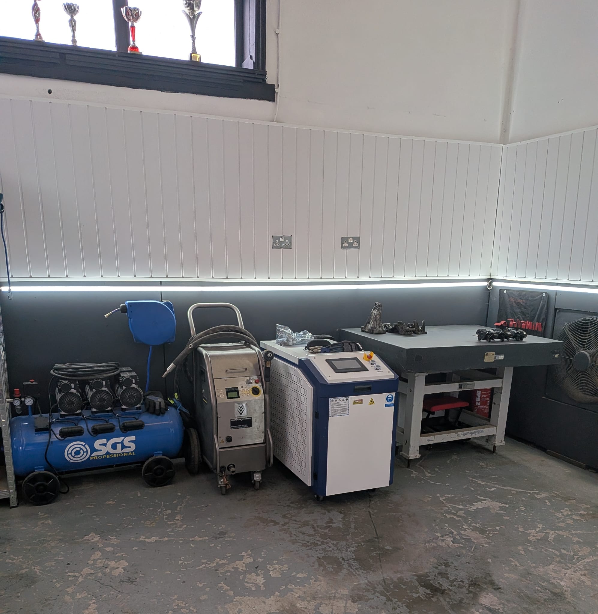 Vehicle on lift at Elite Dry Ice Blasting workshop showing dry ice cleaning equipment